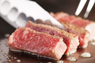 美味しそうな松阪牛のイチボステーキをナイフでカットしている