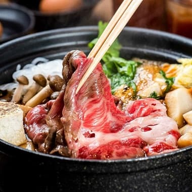 鍋で煮込まれている熊野牛すき焼き肉